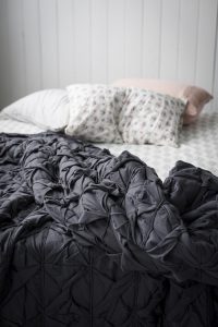 Rumpled comforter on an unmade bed